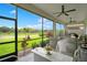 Relaxing screened patio with comfortable seating and a scenic backyard view at 1104 Sawgrass Dr, Winter Haven, FL 33884