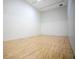 Empty racquetball court with hardwood floors and regulation markings and tall, plain white walls at 1104 Sawgrass Dr, Winter Haven, FL 33884