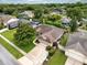 Expansive aerial view of the house showcasing a well-maintained roof, lush landscaping, and the surrounding neighborhood at 1165 Baltic Ln, Winter Springs, FL 32708