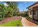 Landscaped backyard featuring a stone path, lush greenery, and meticulous design elements at 1165 Baltic Ln, Winter Springs, FL 32708