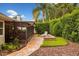 Beautiful backyard with patio seating area, lush greenery, and screened-in porch at 1165 Baltic Ln, Winter Springs, FL 32708