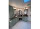 Bathroom featuring a double sink vanity, stylish lighting, and plenty of storage in green cabinets at 1165 Baltic Ln, Winter Springs, FL 32708