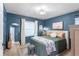 Comfortable bedroom featuring blue walls, ample natural light, and stylish décor at 1165 Baltic Ln, Winter Springs, FL 32708