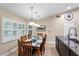 Cozy dining area filled with natural light from large windows, perfect for Gathering meals at 1165 Baltic Ln, Winter Springs, FL 32708