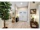 Bright foyer with wood floors, double entry doors, and stylish decor leading to the living spaces at 1165 Baltic Ln, Winter Springs, FL 32708