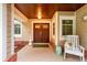 Covered front entry featuring stately double doors, a cozy bench, and lovely decorative accents at 1165 Baltic Ln, Winter Springs, FL 32708