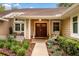 Inviting home entrance with double doors and charming landscaping, creating a warm welcome at 1165 Baltic Ln, Winter Springs, FL 32708