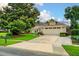 Charming single-story home with a lush front yard and long driveway leading to an attached two car garage at 1165 Baltic Ln, Winter Springs, FL 32708