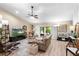 Spacious living room with vaulted ceiling, plush sofa, and views to the outdoor patio at 1165 Baltic Ln, Winter Springs, FL 32708