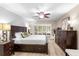 Spacious main bedroom with dark wood accents, ceiling fan, and natural light through shuttered windows at 1165 Baltic Ln, Winter Springs, FL 32708