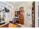 Well-lit home office with built-in desk, ample storage, and a large window at 1165 Baltic Ln, Winter Springs, FL 32708