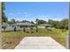 Expansive backyard featuring a charming home with a screened-in lanai, perfect for outdoor relaxation at 13031 Ne 7Th Loop, Silver Springs, FL 34488