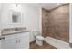 Bathroom featuring granite countertop, tiled shower with upgraded shower head at 13031 Ne 7Th Loop, Silver Springs, FL 34488