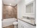 This bathroom features tub shower combo and a vanity with granite counter at 13031 Ne 7Th Loop, Silver Springs, FL 34488