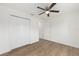 Bedroom featuring wood-look floors, ceiling fan, and double door closet at 13031 Ne 7Th Loop, Silver Springs, FL 34488
