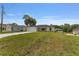 A single-story home with a large front lawn and long concrete driveway offers ample parking space at 13031 Ne 7Th Loop, Silver Springs, FL 34488