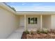 Inviting front porch with manicured landscaping, offering a warm welcome to guests and homeowners at 13031 Ne 7Th Loop, Silver Springs, FL 34488