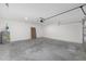 Spacious garage with painted walls and floor with included garage door opener at 13031 Ne 7Th Loop, Silver Springs, FL 34488