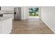 Open kitchen with stainless steel appliances, granite countertops, and a view to the backyard at 13031 Ne 7Th Loop, Silver Springs, FL 34488