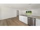 Open concept kitchen featuring stainless steel appliances, granite countertops, and ample cabinet space at 13031 Ne 7Th Loop, Silver Springs, FL 34488