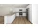 Bright open kitchen showcasing stainless steel appliances, granite countertops, and white cabinets at 13031 Ne 7Th Loop, Silver Springs, FL 34488
