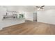 Spacious open-concept living area with wood-look floors, recessed lighting, and a view of the kitchen and dining area at 13031 Ne 7Th Loop, Silver Springs, FL 34488