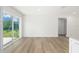 The living room features wood floors, natural lighting, and neutral-colored walls at 13031 Ne 7Th Loop, Silver Springs, FL 34488