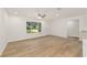Bright living room features wood floors, a large window, and white trim at 13031 Ne 7Th Loop, Silver Springs, FL 34488