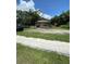 Cozy single-story home with a gravel driveway and a charming white picket fence at 1307 Mabbette St, Kissimmee, FL 34741