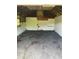 Empty garage interior with exposed roof beams and walls at 1307 Mabbette St, Kissimmee, FL 34741