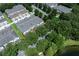 Aerial view of townhouses surrounded by mature trees and a scenic pond at 14128 Avenue Of The Grvs, Winter Garden, FL 34787