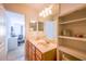 Elegant bathroom with double sinks, shelving, and natural light, offering a spa-like experience at 14128 Avenue Of The Grvs, Winter Garden, FL 34787