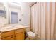 Standard bathroom with vanity, toilet, and shower featuring decorative curtain at 14128 Avenue Of The Grvs, Winter Garden, FL 34787