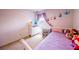 Bedroom featuring a purple princess theme with a dresser and desk for a whimsical space at 14128 Avenue Of The Grvs, Winter Garden, FL 34787