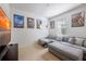 Inviting bedroom with a comfortable gray sectional sofa and creative wall art at 14128 Avenue Of The Grvs, Winter Garden, FL 34787