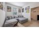 Cozy bedroom features a comfortable gray sectional sofa, soft carpet, and creative wall art at 14128 Avenue Of The Grvs, Winter Garden, FL 34787