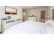 Bright bedroom featuring a TV, white furnishings, and a serene, relaxing ambiance at 14128 Avenue Of The Grvs, Winter Garden, FL 34787