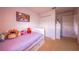 Charming bedroom with playful decor, featuring plush toys and cozy sleeping space at 14128 Avenue Of The Grvs, Winter Garden, FL 34787