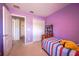 Cozy bedroom featuring closet and a bed with a striped comforter at 14128 Avenue Of The Grvs, Winter Garden, FL 34787