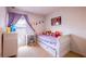 Cozy bedroom decorated with soft colors, including a desk and play area for children at 14128 Avenue Of The Grvs, Winter Garden, FL 34787
