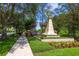Landscaped community entrance with sidewalks and manicured lawn at 14128 Avenue Of The Grvs, Winter Garden, FL 34787