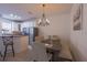 Bright dining area adjacent to the kitchen, featuring a modern chandelier and neutral decor at 14128 Avenue Of The Grvs, Winter Garden, FL 34787