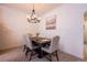 Charming dining room featuring a rustic wood table, upholstered chairs, and a stylish chandelier at 14128 Avenue Of The Grvs, Winter Garden, FL 34787