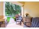 Cozy front porch featuring comfortable seating, decorative plants, and a serene view of the neighborhood at 14128 Avenue Of The Grvs, Winter Garden, FL 34787