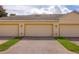 Attached two-car garage with red brick driveway and manicured lawn at 14128 Avenue Of The Grvs, Winter Garden, FL 34787