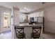 Charming kitchen featuring white cabinets, stainless steel appliances, and a cozy breakfast bar with seating at 14128 Avenue Of The Grvs, Winter Garden, FL 34787
