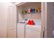 Compact laundry room with washer, dryer, and shelving for storage at 14128 Avenue Of The Grvs, Winter Garden, FL 34787
