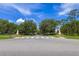 Community entrance featuring brick pillars and mature trees, welcoming you to the neighborhood at 14128 Avenue Of The Grvs, Winter Garden, FL 34787