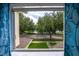 Scenic view from a window overlooking green grass, trees, a parking area, and a pond at 14128 Avenue Of The Grvs, Winter Garden, FL 34787