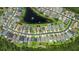 Aerial view of the neighborhood with homes surrounding a large pond with fountain at 1509 Cedar Lake Dr, Orlando, FL 32824
